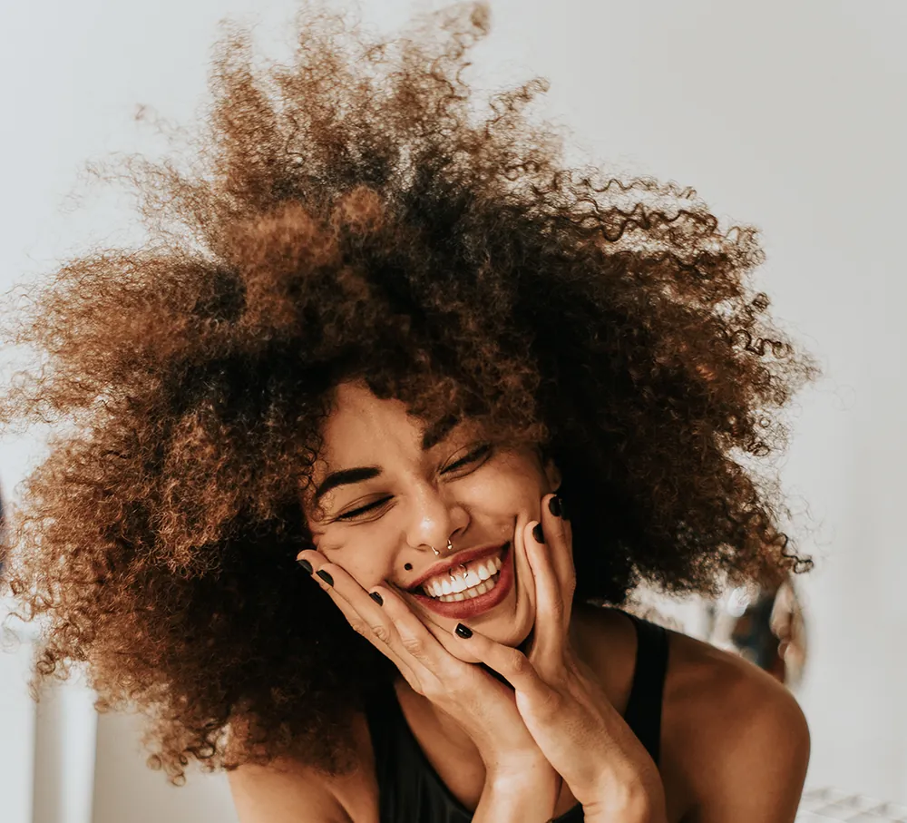 Smiling woman with natural brunette curls