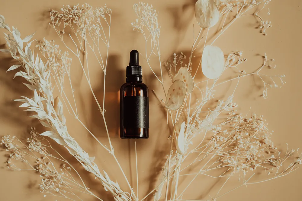 Essential oil bottle with dried grasses