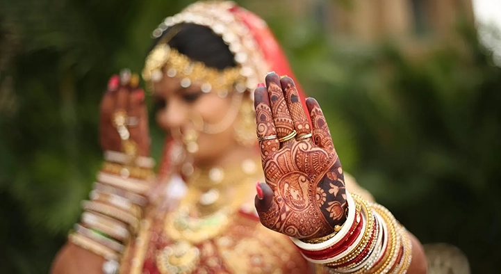 Bride showing her hand decorated with henna mehndi